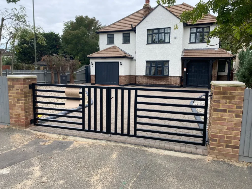 Front of a renovated detached house with new gates and driveway – Tenfold Renovation