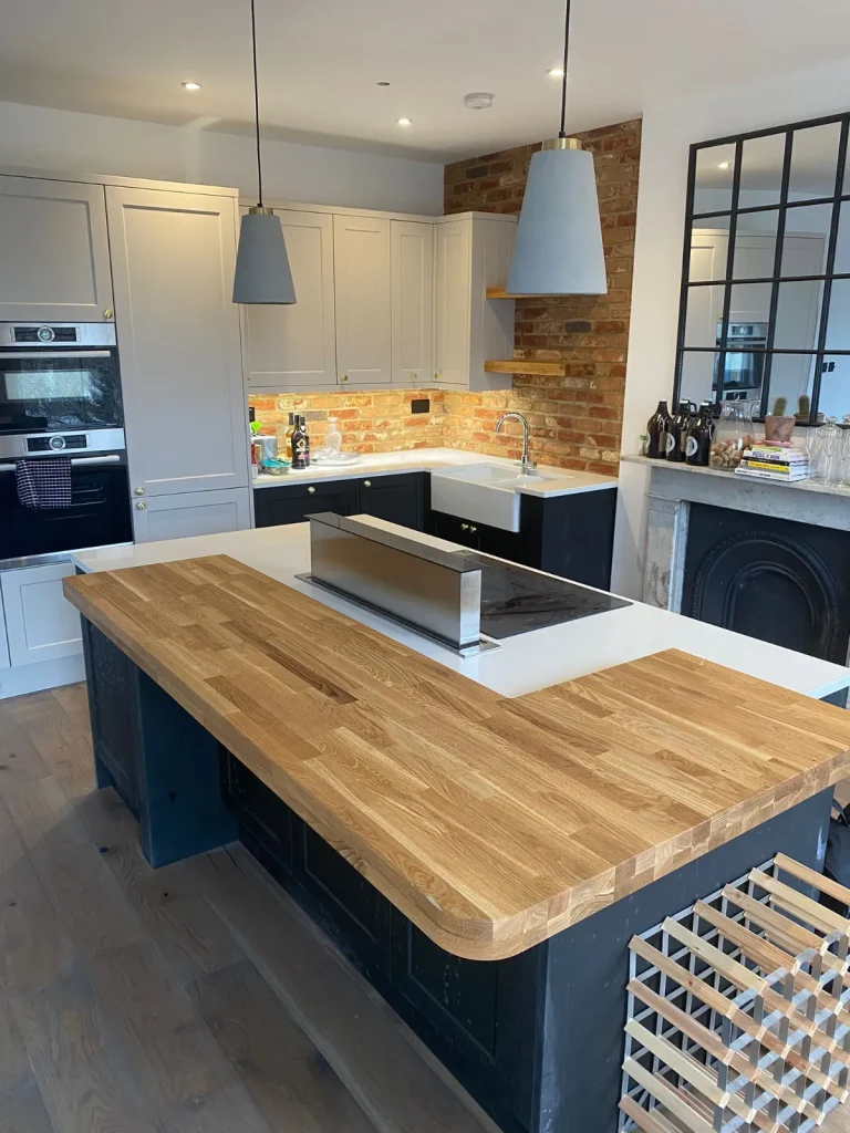 Kitchen island with wooden worktop and built-in ovens – Tenfold Renovation