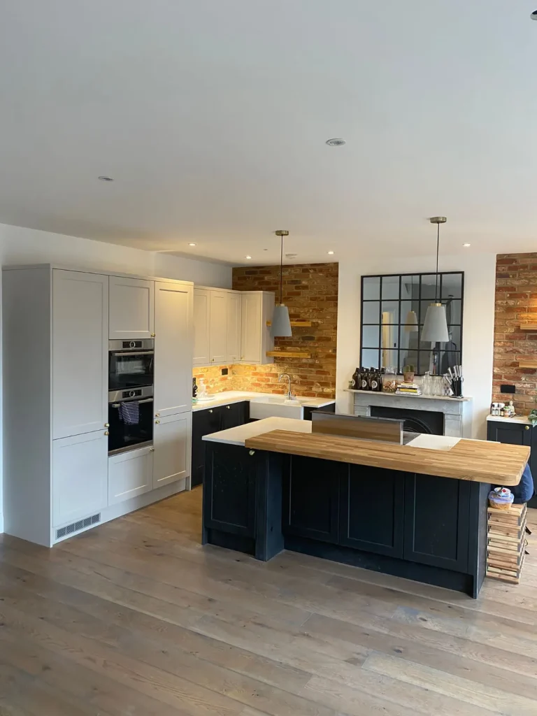 Kitchen renovation with navy island and pendant lights – Tenfold Renovation
